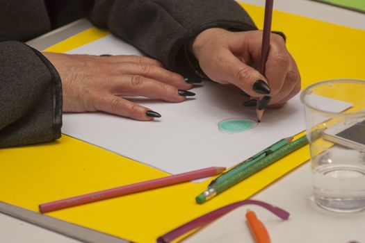 LUSIA, ITALY 23 MARCH 2020: Art Therapy school with people who draw and color their drawings for therapeutic purposes