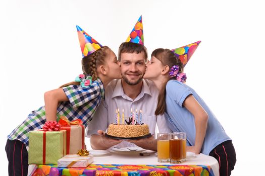 Children congratulated father on his birthday and kiss him on the cheek