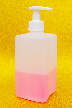 Antibacterial disinfectant soap. Liquid pink soap in white bottle.