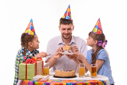 Children ask dad for their piece of holiday cake
