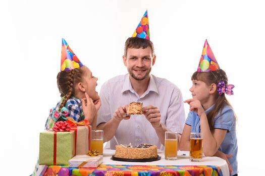 Children ask dad for a piece of holiday cake