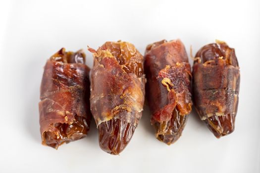 spanish dates with ham on a plate