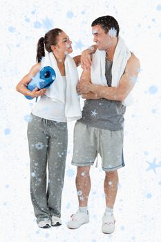 Composite image of Portrait of a happy couple going to practice yoga with snow falling