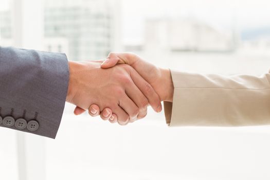 Close-up of business people shaking hands in the office
