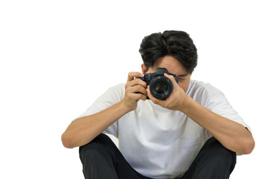 The photographer looks through the viewfinder while shooting with the camera.