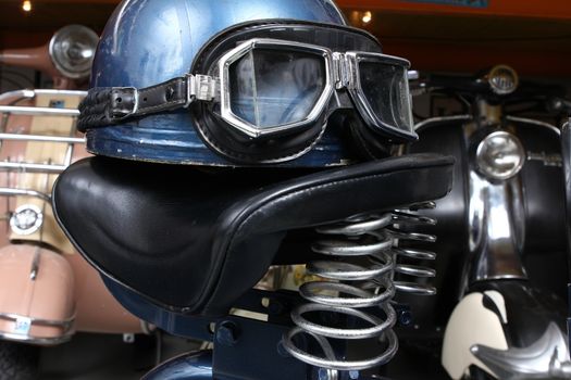 Old biker helmet and goggles with blue colors