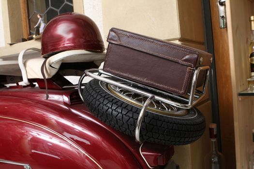 Old biker helmet and goggles with red helmet