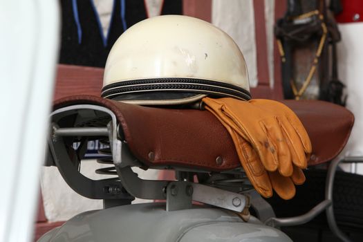 Old biker helmet and goggles with white helmet