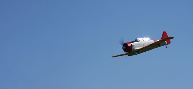 world war2 plane in flight with blue sky