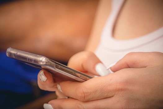 Young woman using a smartphone. Close up, selective focus with copy space.