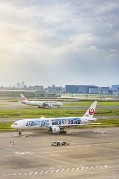 japanese JAL boeing plane decorated with a giant sticker of the soccer national team Samurai Blue 2018 for Football World Cup at Tokyo Narita International Airport.