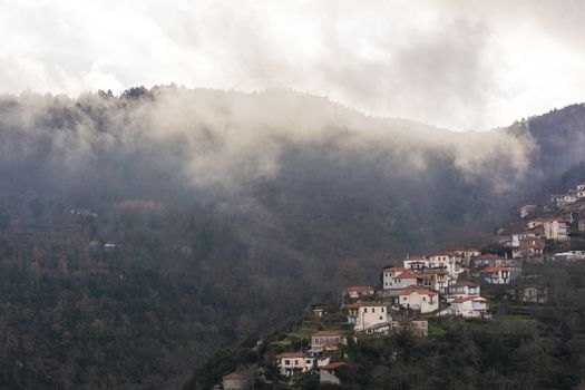 Image of village in the mountains with fog, Arcadia, Greece.