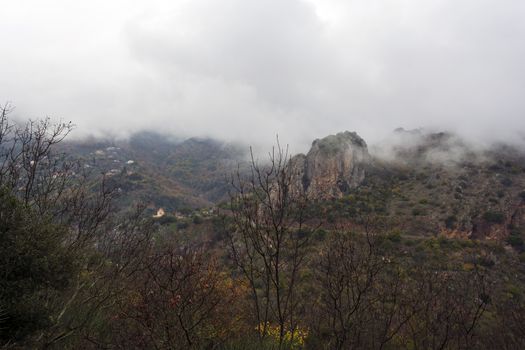 Image of village in the mountains with fog, Arcadia, Greece.