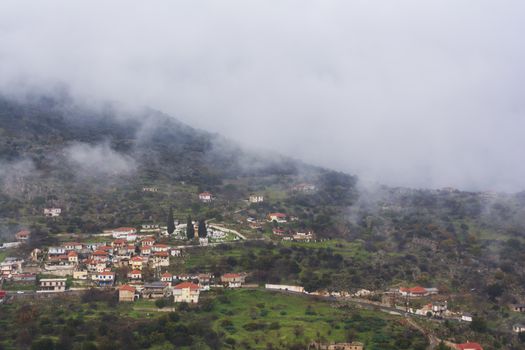 Image of village in the mountains with fog, Arcadia, Greece.