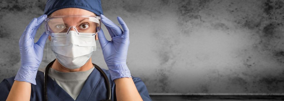 Female Doctor or Nurse Wearing Scrubs and Protective Mask and Goggles Banner.