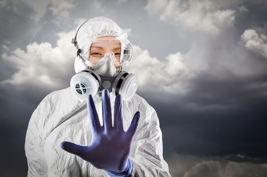 Chinese Woman Wearing Hazmat Suit, Protective Gas Mask and Goggles With Stormy Background.