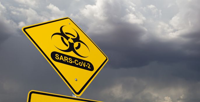 Bio-hazard Symbol With SARS-CoV-2 Coronaravirus Yellow Road Sign Against Ominous Stormy Cloudy Sky.