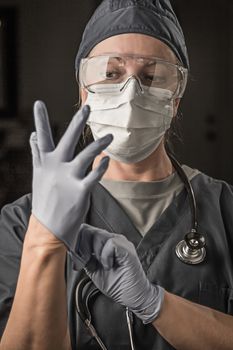 Female Doctor or Nurse Wearing Scrubs, Protective Face Mask and Goggles.