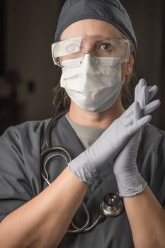 Female Doctor or Nurse Wearing Scrubs, Protective Face Mask and Goggles.