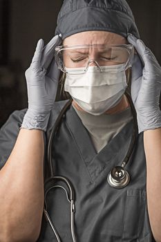 Female Doctor or Nurse Wearing Scrubs, Protective Face Mask and Goggles.