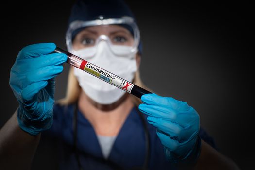 Female Lab Worker Holds Test Tube of Blood Labeled Coronavirus COVID-19 Disease.