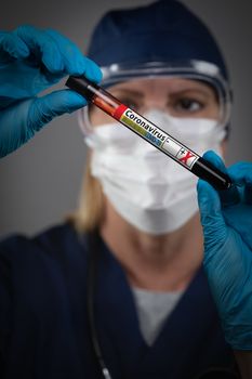 Female Lab Worker Holds Test Tube of Blood Labeled Coronavirus COVID-19 Disease.