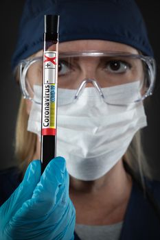 Female Lab Worker Holds Test Tube of Blood Labeled Coronavirus COVID-19 Disease.