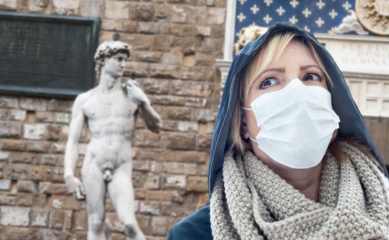 Young Woman Wearing Face Mask Walks Near the Statue of David in the Piazza della Signoria Italy.