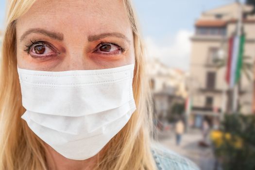 Sick Infected Young Woman Wearing Face Mask Walks on Street In Italy.