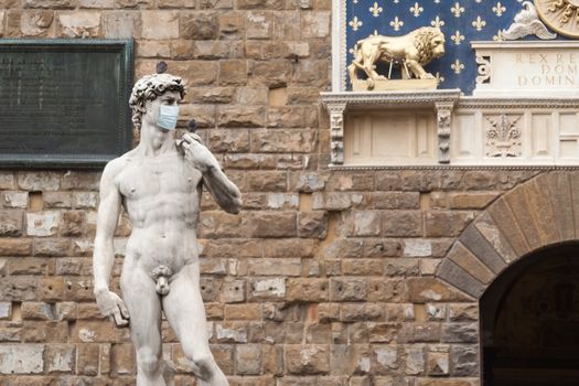 The Statue Of David in the Piazza della Signoria In Italy Wearing a Protective Face Mask.