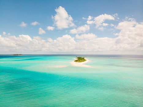 Picture perfect beach and turquoise lagoon on small tropical island on Maldives.
