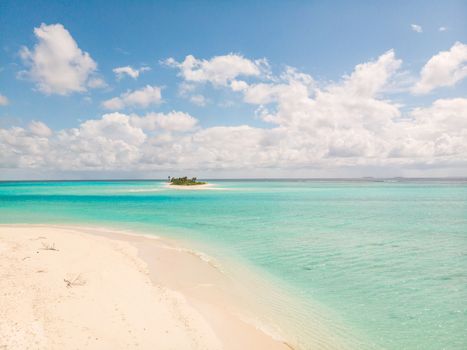 Picture perfect beach and turquoise lagoon on small tropical island on Maldives.