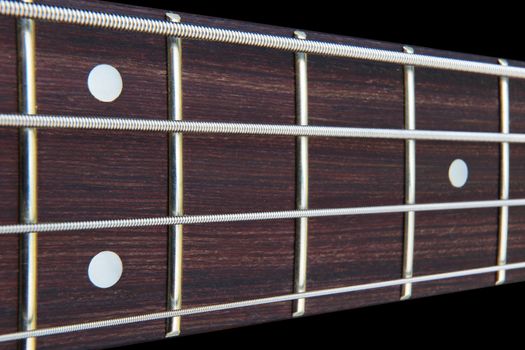 A Four string bass guitar fretboard neck with selective focus
