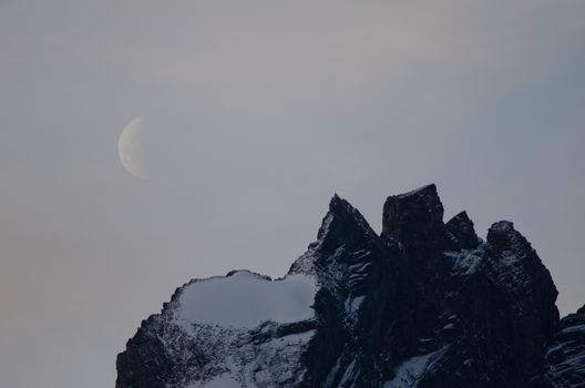 Moon on a cliff in the Torres del Paine National Park. Ultima Esperanza Province. Magallanes and Chilean Antarctic Region. Chile.