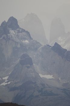 Paine Horns in the foreground and Towers of Paine in the background. Torres del Paine National Park. Ultima Esperanza Province. Magallanes and Chilean Antarctic Region. Chile.