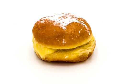 Bola de Berlim, or Berlim Ball, a Portuguese pastry made from a fried donut filled with sweet eggy cream and rolled in crunchy sugar on a white background.