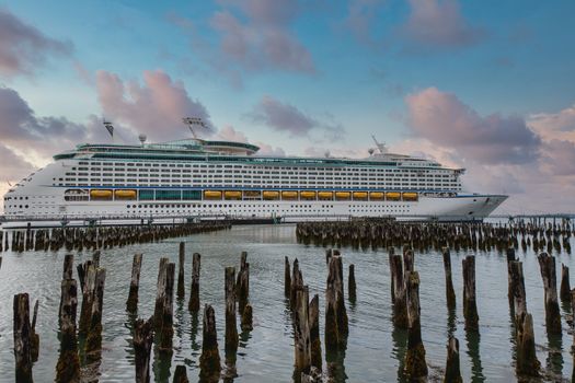 A luxury cruise ship in Portland harbor beyond wood pilings