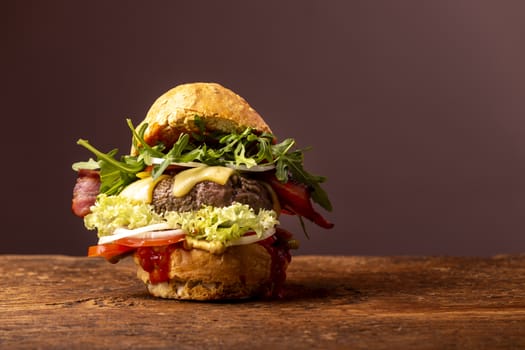 single hamburger on dark wood