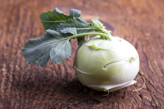 single raw cabbage turnip on wood