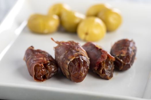 spanish dates with ham on a plate