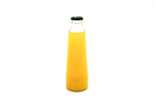 Close up view of fresh pineapple juice in glass bottle on a white background