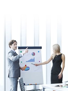 Businessman making financial presentation on flipchart at business meeting