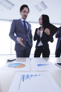 Business people discussing financial reports at office table