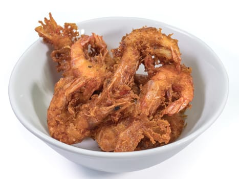 The close up of deep fried shrimp in white bowl on white background.
