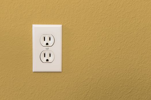 Electrical Sockets In Colorful Mustard Yellow Wall of House.