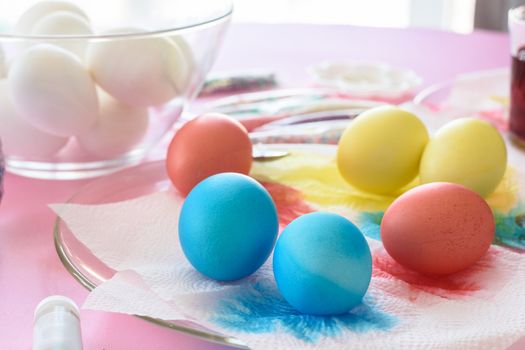 Painting in different colors of eggs for Easter