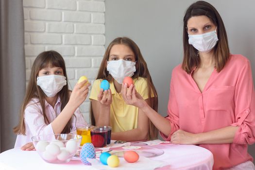 quarantined family paints eggs for easter
