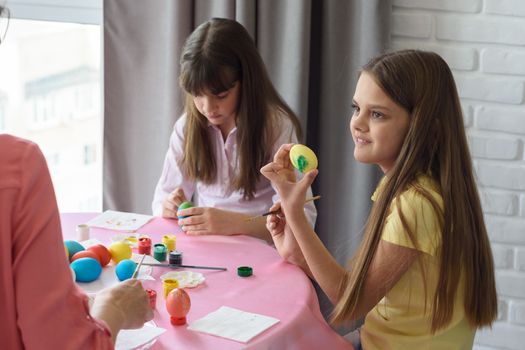 Child shows mom painted easter egg