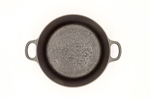 Cast iron pan with two handles top view on a white background