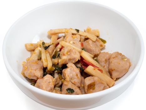 The close up of Fried Spicy Bamboo Shoot With fish ball (Thai food) in white bowl on white background.